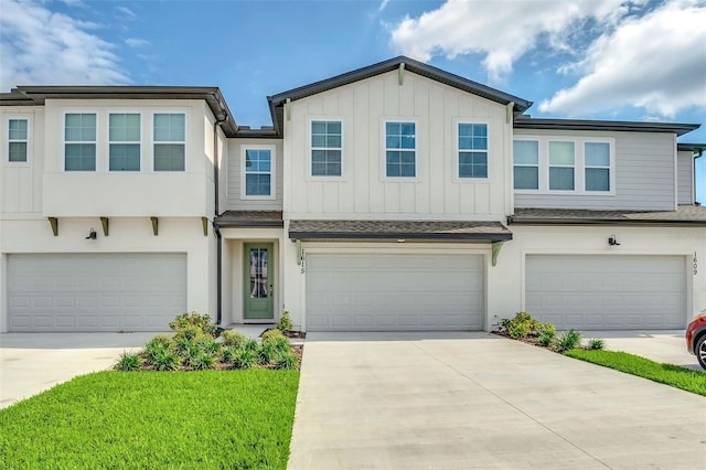 1615 Sanibel Dr, Davenport, FL 33896 - view of property featuring a garage, driveway, board and batten siding, and a shingled roof