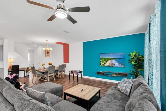 1615 Sanibel Dr, Davenport, FL 33896 - living room with a chandelier, wood finished floors, ceiling fan, and baseboards