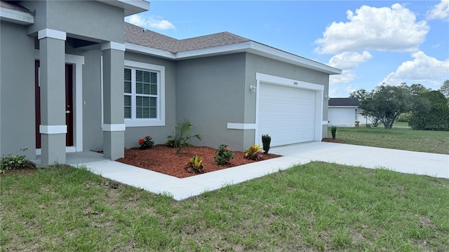 3498 SW 131st Place Rd, Ocala, FL 34473 - view of side of home with stucco siding, an attached garage, a lawn, driveway, and a shingled roof