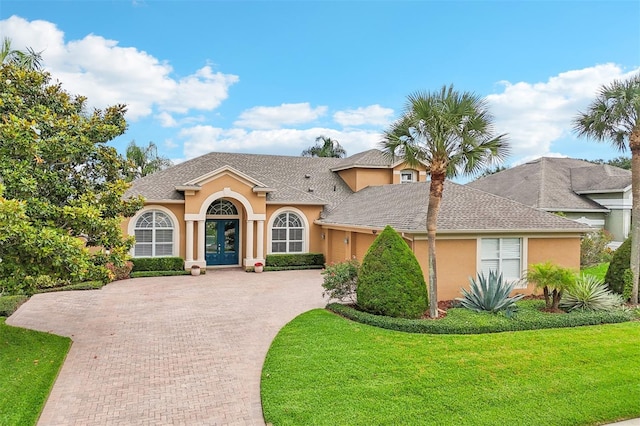 13524 Glynshel Dr, Winter Garden, FL 34787 - view of front of property featuring french doors, stucco siding, decorative driveway, a front yard, and roof with shingles