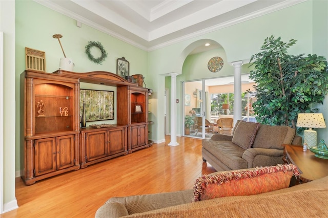 13524 Glynshel Dr, Winter Garden, FL 34787 - living area with decorative columns, light wood finished floors, ornamental molding, a tray ceiling, and arched walkways