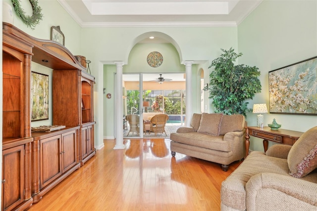13524 Glynshel Dr, Winter Garden, FL 34787 - living area with decorative columns, arched walkways, light wood-style flooring, a high ceiling, and a ceiling fan
