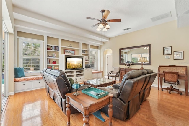 13524 Glynshel Dr, Winter Garden, FL 34787 - living room featuring arched walkways, a ceiling fan, light wood-type flooring, and baseboards