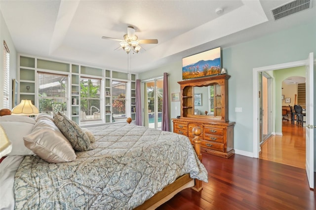 13524 Glynshel Dr, Winter Garden, FL 34787 - bedroom with a raised ceiling, access to exterior, wood finished floors, arched walkways, and a ceiling fan