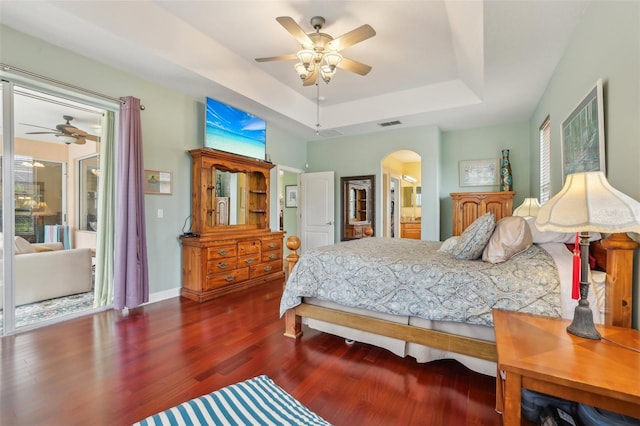 13524 Glynshel Dr, Winter Garden, FL 34787 - bedroom featuring a raised ceiling, arched walkways, wood finished floors, a ceiling fan, and access to outside