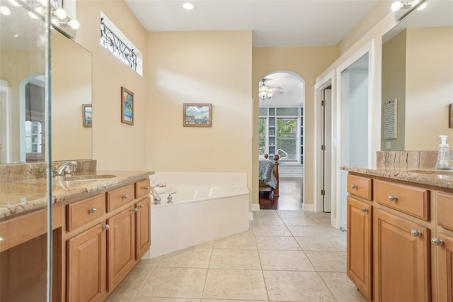 13524 Glynshel Dr, Winter Garden, FL 34787 - bathroom featuring a ceiling fan, tile patterned floors, two vanities, a bath, and ensuite bathroom