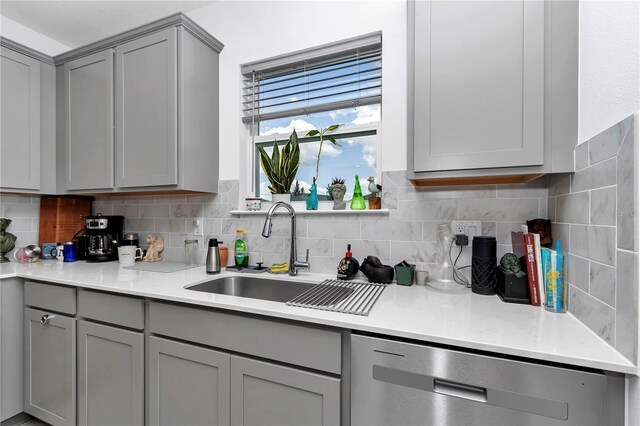 8413 SW 54th Loop, Ocala, FL 34481 - kitchen with gray cabinets, stainless steel dishwasher, a sink, and light countertops