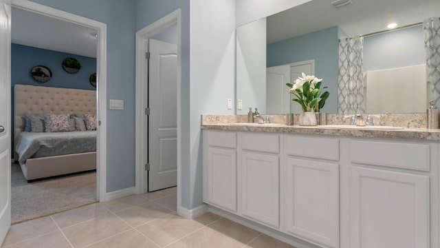 4912 Kaia Ave, Winter Haven, FL 33884 - bathroom featuring connected bathroom, baseboards, tile patterned floors, and double vanity