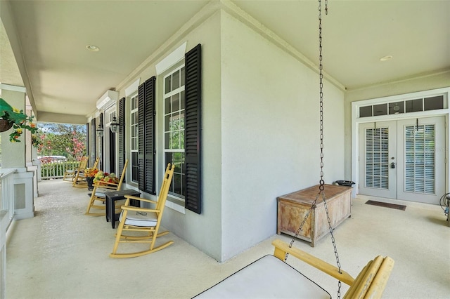 view of patio / terrace with french doors and a porch
