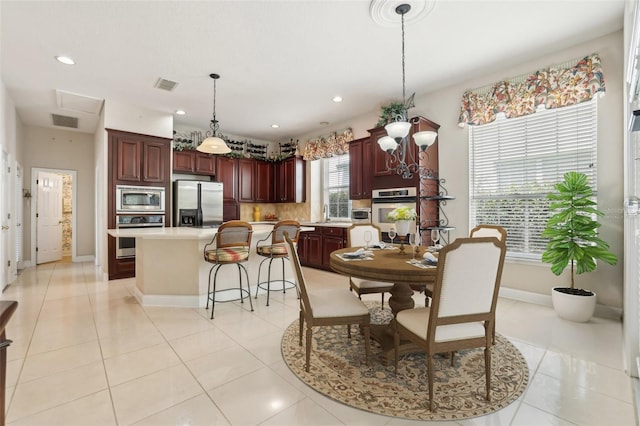 dining room with baseboards, recessed lighting, and light tile patterned floors