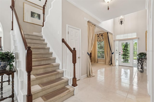 entrance foyer with stairway and light tile patterned floors