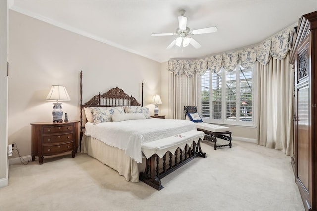 bedroom featuring light carpet, baseboards, a ceiling fan, and ornamental molding