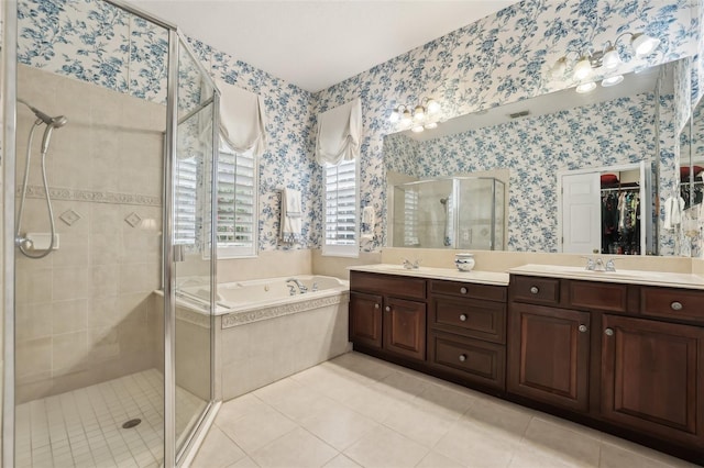 bathroom featuring a stall shower, a garden tub, tile patterned floors, double vanity, and wallpapered walls