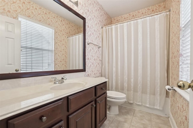 bathroom featuring wallpapered walls, toilet, vanity, tile patterned floors, and shower / bath combo