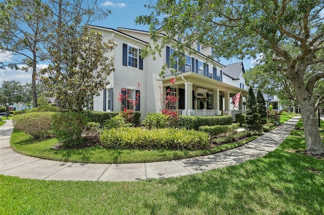 view of front of house with stucco siding and a front yard