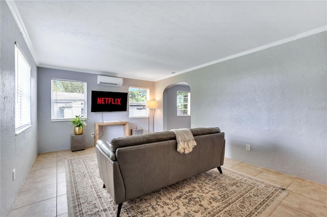 living area featuring crown molding, arched walkways, a wall mounted AC, light tile patterned floors, and a textured wall