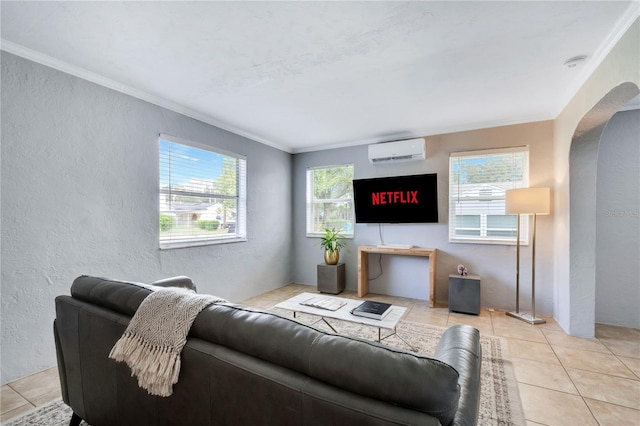 living room featuring a wall mounted AC, a textured wall, crown molding, arched walkways, and light tile patterned flooring
