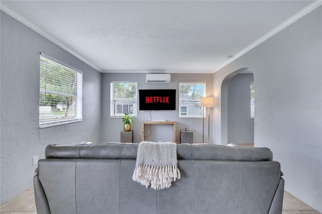tiled living area featuring a wall mounted air conditioner, a textured wall, arched walkways, and crown molding