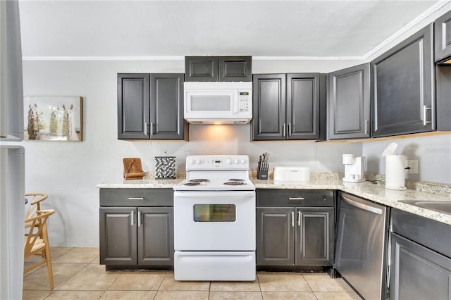 kitchen with white appliances, light tile patterned floors, light stone counters, and crown molding