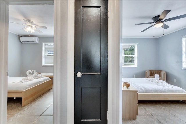 tiled bedroom with crown molding, a wall unit AC, and a ceiling fan