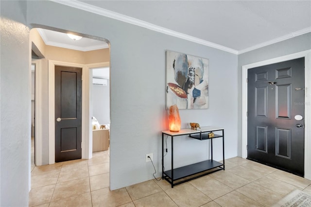 entryway with arched walkways, light tile patterned flooring, ornamental molding, and a wall mounted AC