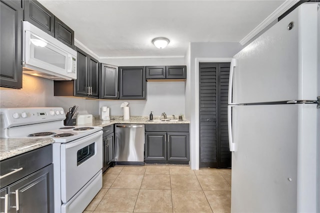 kitchen featuring white appliances, a sink, crown molding, light tile patterned floors, and light stone countertops