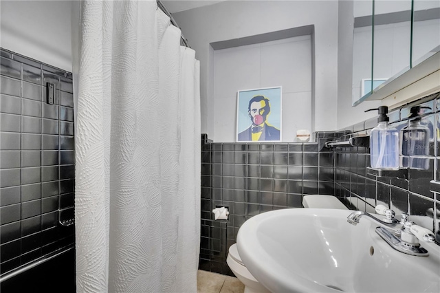 bathroom featuring a sink, tile walls, and a shower with shower curtain