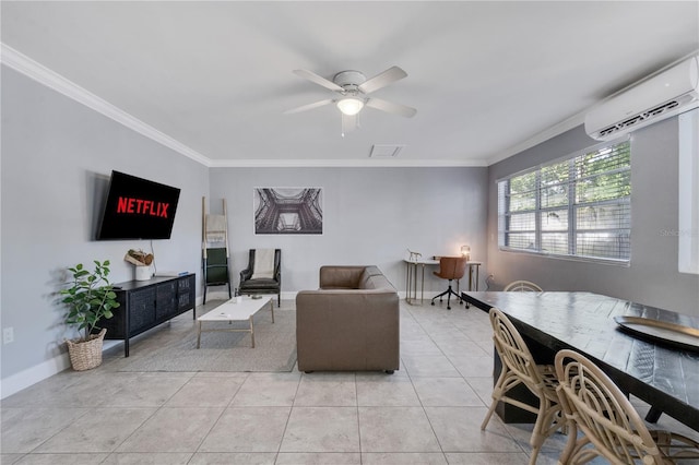 living room featuring an AC wall unit, ornamental molding, a ceiling fan, light tile patterned floors, and baseboards