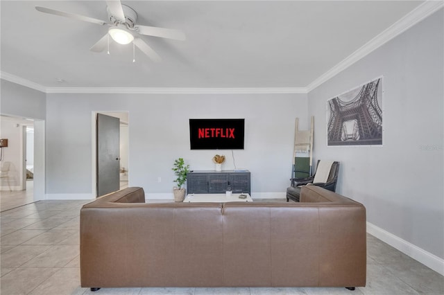 living room featuring ornamental molding, light tile patterned floors, a ceiling fan, and baseboards