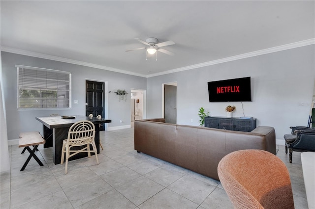 living room featuring ceiling fan, ornamental molding, light tile patterned floors, and baseboards