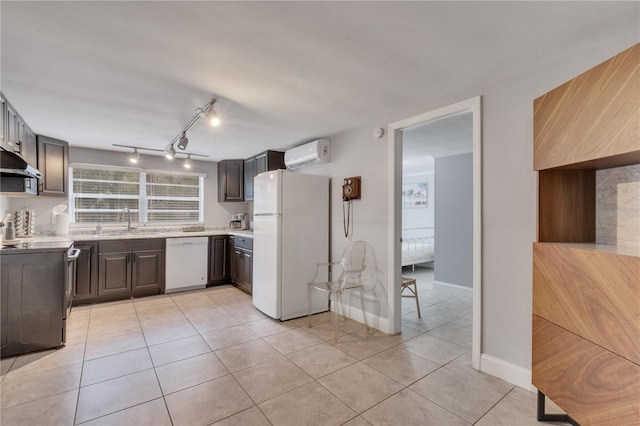 kitchen with white appliances, a sink, a wall mounted air conditioner, light countertops, and light tile patterned flooring