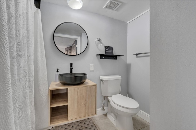 full bath with tile patterned floors, toilet, baseboards, and vanity