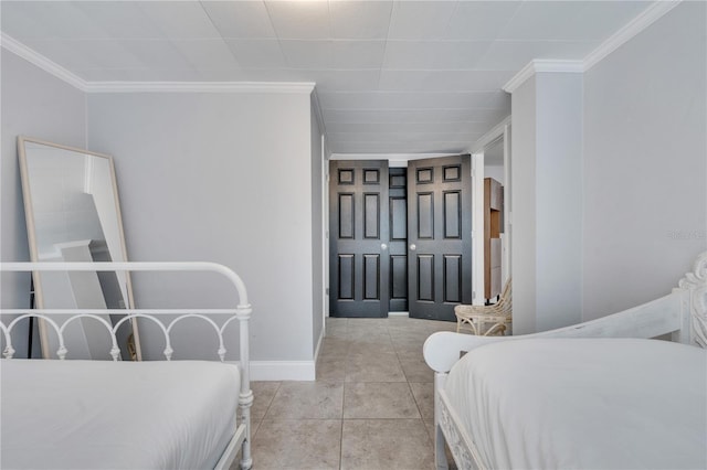 bedroom featuring crown molding, baseboards, and light tile patterned floors