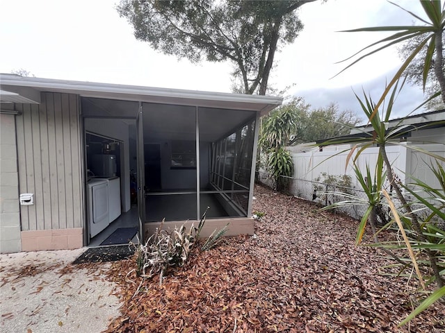 property entrance with independent washer and dryer and fence