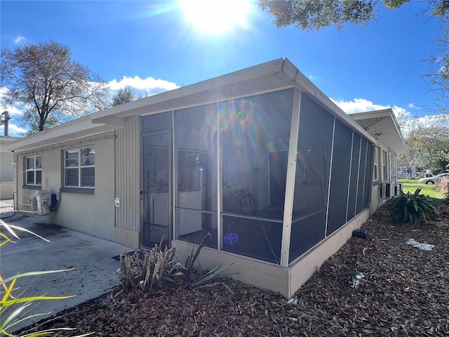 view of home's exterior with a sunroom