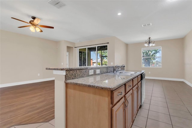 kitchen featuring a sink, healthy amount of natural light, baseboards, light tile patterned flooring, and recessed lighting