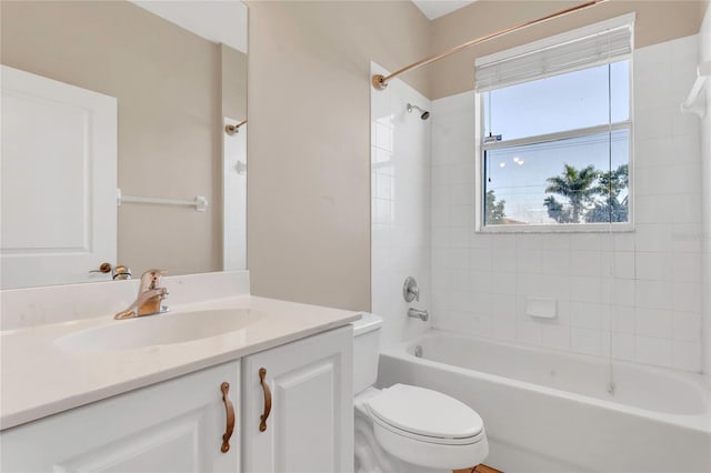 bathroom featuring toilet, shower / bathtub combination, and vanity