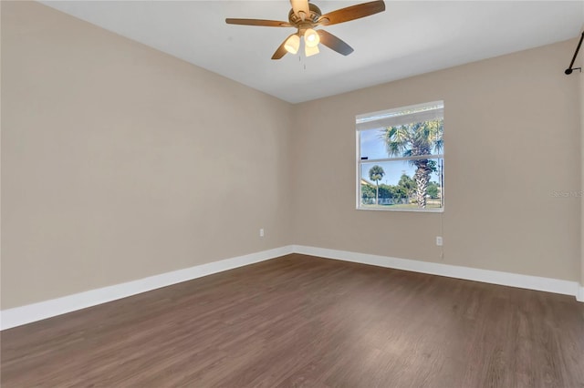 empty room with dark wood finished floors, baseboards, and ceiling fan