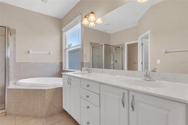 full bathroom with a stall shower, tile patterned floors, a bath, and double vanity