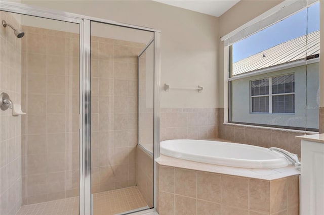 full bath featuring a shower stall and a bath