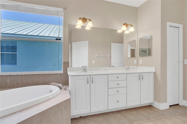 bathroom featuring tile patterned flooring, a garden tub, and double vanity