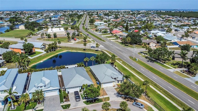aerial view of residential area featuring a nearby body of water