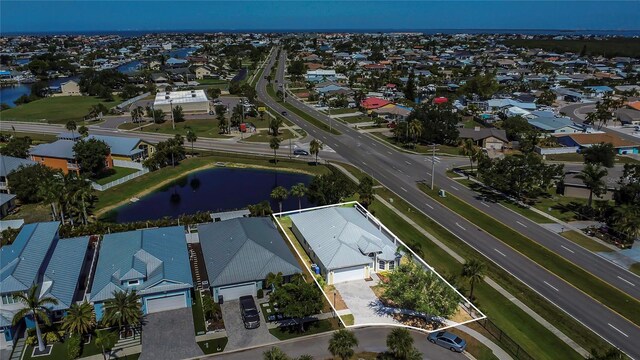 aerial view of residential area featuring a large body of water and property boundaries highlighted