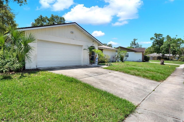 ranch-style home featuring concrete driveway, a front yard, and a garage