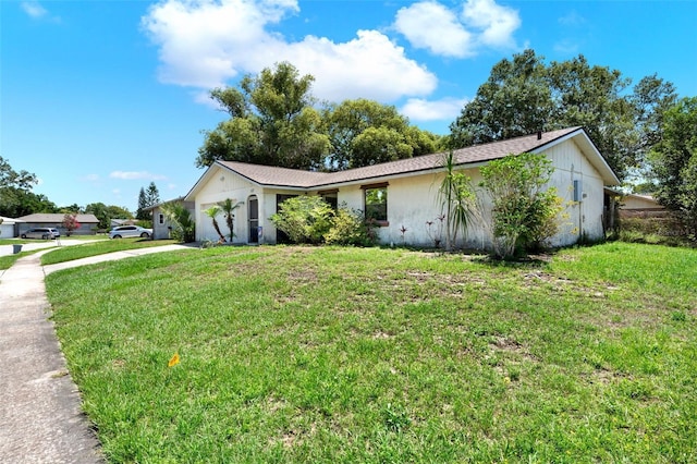 view of property exterior with driveway, a garage, and a yard