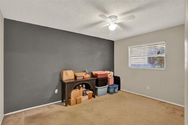 interior space with baseboards, a textured ceiling, and a ceiling fan
