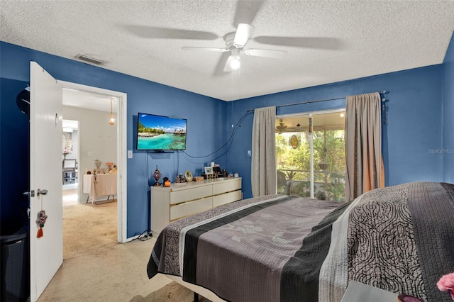 carpeted bedroom with a textured ceiling and ceiling fan