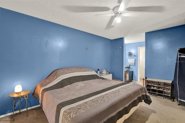 carpeted bedroom featuring a textured ceiling, ceiling fan, and baseboards