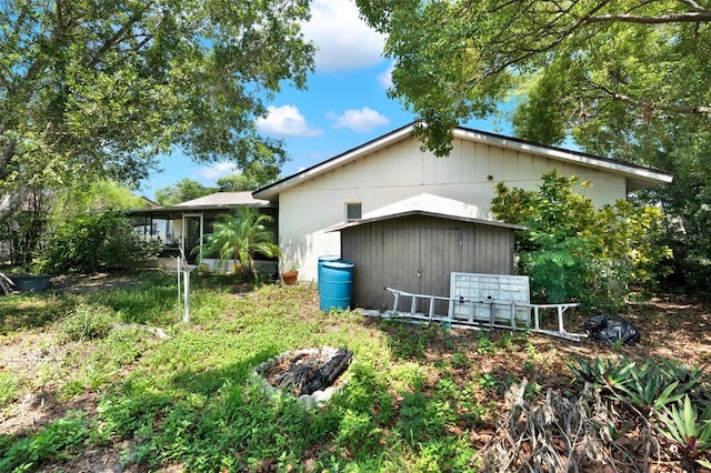 view of home's exterior with a storage unit and an outdoor structure