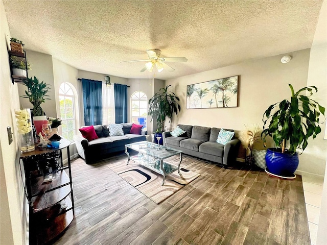 2376 Flamingo Lakes Dr, Kissimmee, FL 34743 - living room featuring wood finished floors, a ceiling fan, baseboards, and a textured ceiling